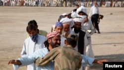 A soldier checks a man fleeing a military offensive in South Waziristan. (file photo)