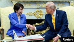 US President Donald Trump shakes hands with Japanese Prime Minister Sanae Takaichi in the Oval Office at the White House in Washington on March 19.