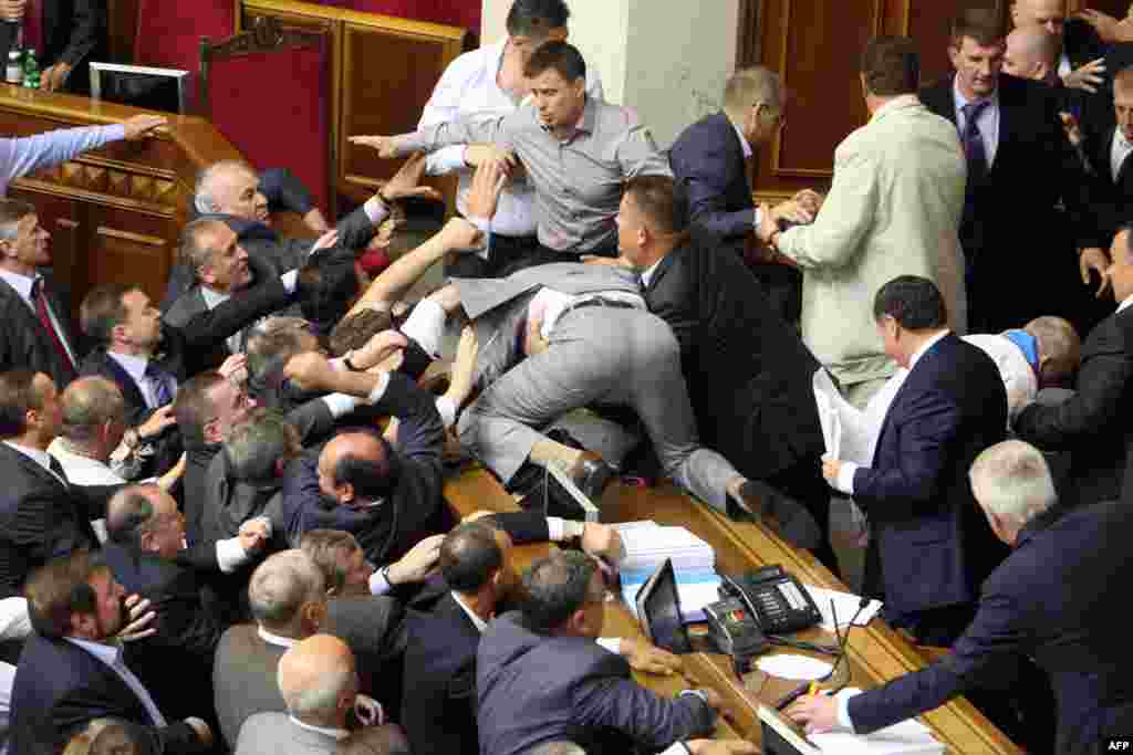 A brawl erupts among balding politicians inside Kyiv&#39;s parliament in May 2012 during a &quot;hearing&quot; on a bill dealing with the use of the Russian language in Ukraine&#39;s east.&nbsp;