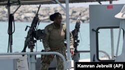 U.S. Navy personnel prepare at a patrol boat to carry journalists to see damaged oil tankers during a trip organized by the Navy for journalists, near Fujairah, June 19, 2019