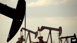 In this April 24, 2015 file photo, pumpjacks work in a field near Lovington, N.M. File photo