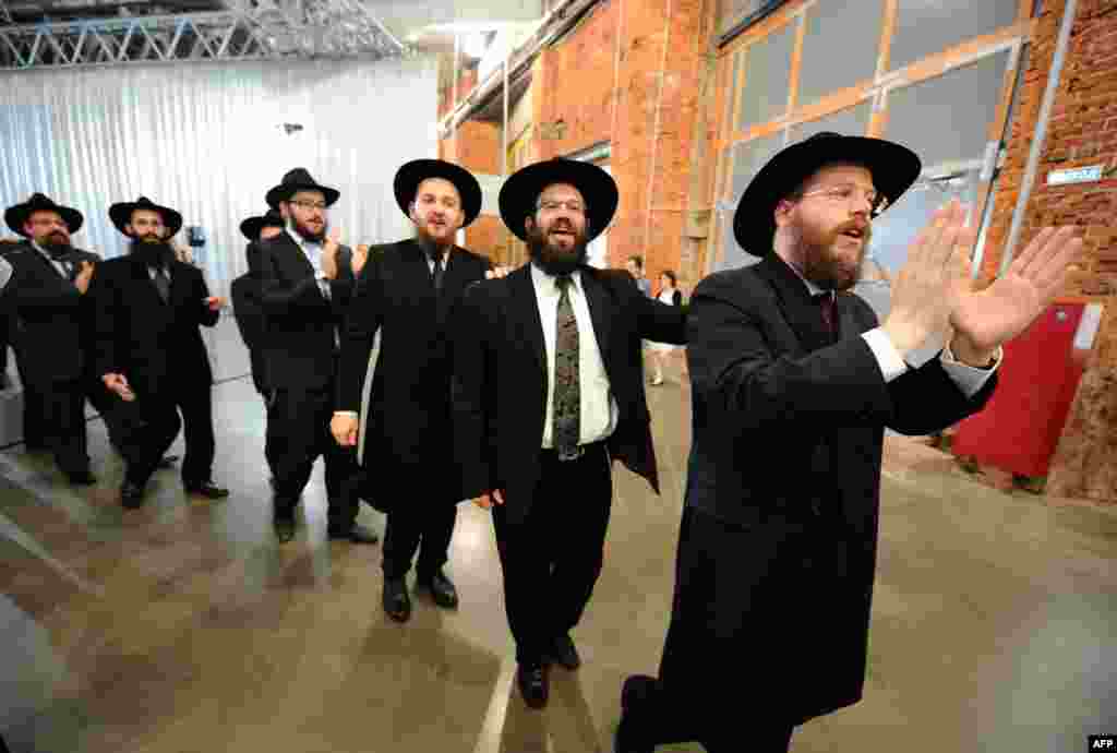 Jews sing and dance as they celebrate the handover of the Schneerson library at the Jewish Museum and Tolerance Center in Moscow on June 13. The library&#39;s Jewish archive has been the subject of a long-running dispute between Russia and the United States. (AFP/Yuri Kadobnov)