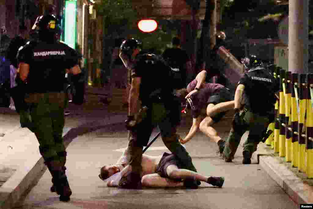 Police tackle protesters to the ground on June 28. Serbia's student-led protests have intensified after law-enforcement officers began violently detaining participants in a massive rally in Belgrade on June 28.