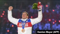 Russian gold-medalist Aleksandr Legkov celebrates on the podium during the men's cross-country skiing 50-kilometer mass-start free victory ceremony at the Sochi Winter Olympics in February 2014.