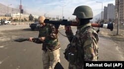 Afghan security personnel arrive at the site of an attack on an intelligence training center in Kabul on December 18.