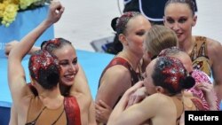 Russia's synchronized swimmers celebrate winning the gold medal.