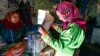 A woman casts a ballot at her home during early voting in Russia's parliamentary elections at a deer camp about 2,200 kilometers northeast of Moscow in the Tyumen region on September 9.