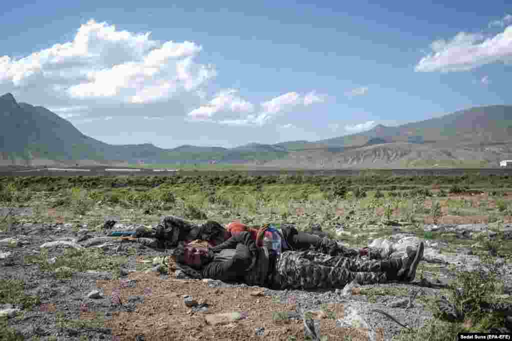 Three Afghans rest next to a highway near the eastern Turkish city of Bitlis on June 2. They travelled west from Afghanistan through Iran as fighting in their home country escalated.