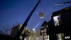 Рятувальники розчищають завали ліцею після російського удару в Нікополі, 11 жовтня 2023 року 