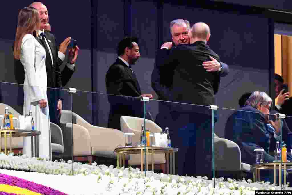 Tajik President Emomali Rahmon (right) embraces his Russian counterpart, Vladimir Putin, during the opening ceremony of the games. On the left is Azerbaijani President Ilham Aliyev.
