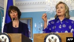 U.S. Secretary of State Hillary Clinton (right) and European Union foreign policy chief Catherine Ashton (left) say they are cautiously optimistic about Iran's offer to discuss its nuclear program (file photo). 