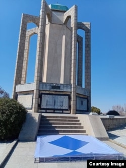 A blue shield symbol in front of the Tomb of Baba Tahir in Hamadan, western Iran.