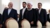 Iranian President Hassan Rohani (center right) walks with Iranian Foreign Minister Mohammad Javad Zarif (left).