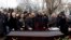 Relatives and other mourners gathered around the coffin at the funeral in Volgograd on December 31 to bury the first of the dozens killed on December 29 and 30.