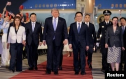 US President Donald Trump (center) arrives at Beijing airport on May 13.