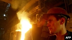 A metalworker works at the Iron and Steel Factory in the Ukrainian city of Mariupol in 2008