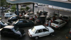 Car line up at a gas station in Tehran on August 27 as the country faces a shortage of fuel reserves.