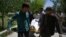 Afghan volunteers bring the body of a resident killed in a car-bomb attack to the Wazir Akbar Khan hospital in Kabul on May 31.