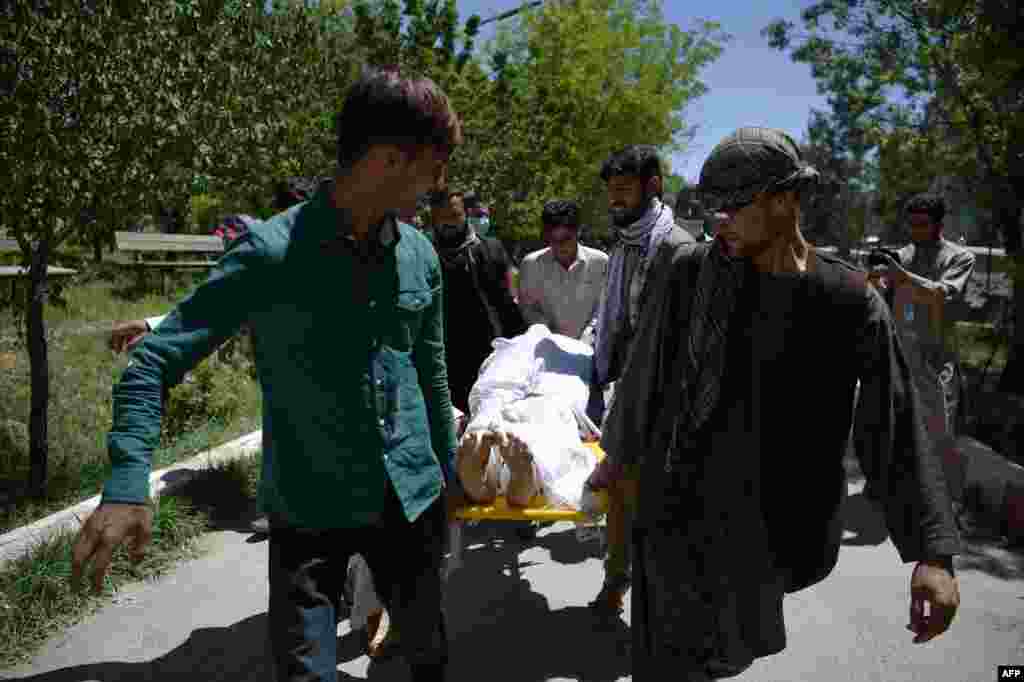 Afghan volunteers bring the body of a resident killed in the attack to the Wazir Akbar Khan hospital.