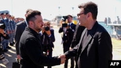 UK Prime Minister Andy Burnham (right) greets Ukrainian President Volodymyr Zelenskyy as they view Ukrainian equipment and meet Ukrainian personnel during a visit to a naval base in Portsmouth on July 27. 