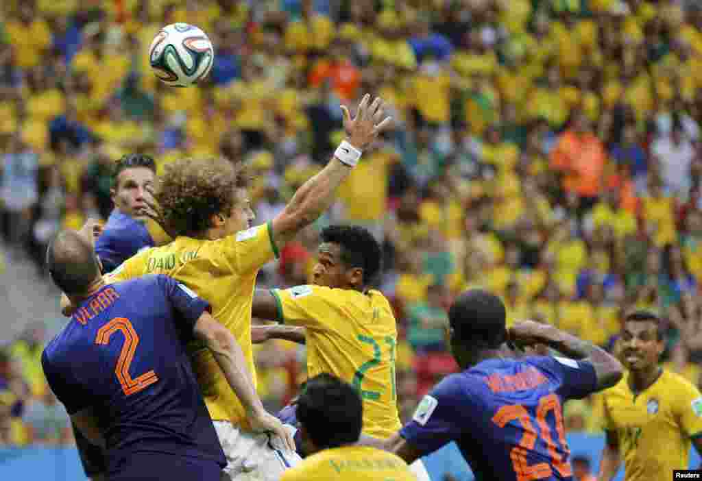 Brazil's David Luiz (2nd L) appeals for a foul as he fights for the header with Ron Vlaar (L) of the Netherlands during their 2014 World Cup third-place playoff at the Brasilia national stadium in Brasilia July 12, 2014