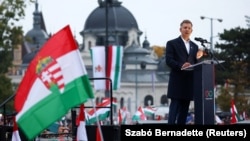 Peter Magyar, leader of the opposition Tisza party, delivers a speech in Budapest at a rally to mark the 69th anniversary of the 1956 Hungarian uprising.