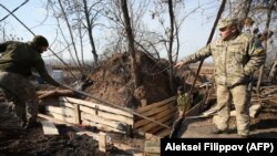 Ukrainian soldiers dig and equip trenches at their new positions not far from the town of Zolote in the Luhansk region on November 2. 