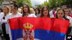 Protesters carry a Serbian flag on the streets of Zvecan, northern Kosovo, on May 31. 
