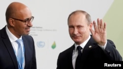 Harlem Desir (L) with Russian President Vladimir Putin in 2015 when he was a French state secretary