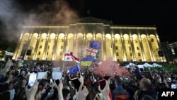 Protesters rally against the "foreign influence" bill outside the Georgian parliament the day after its passage on May 15.