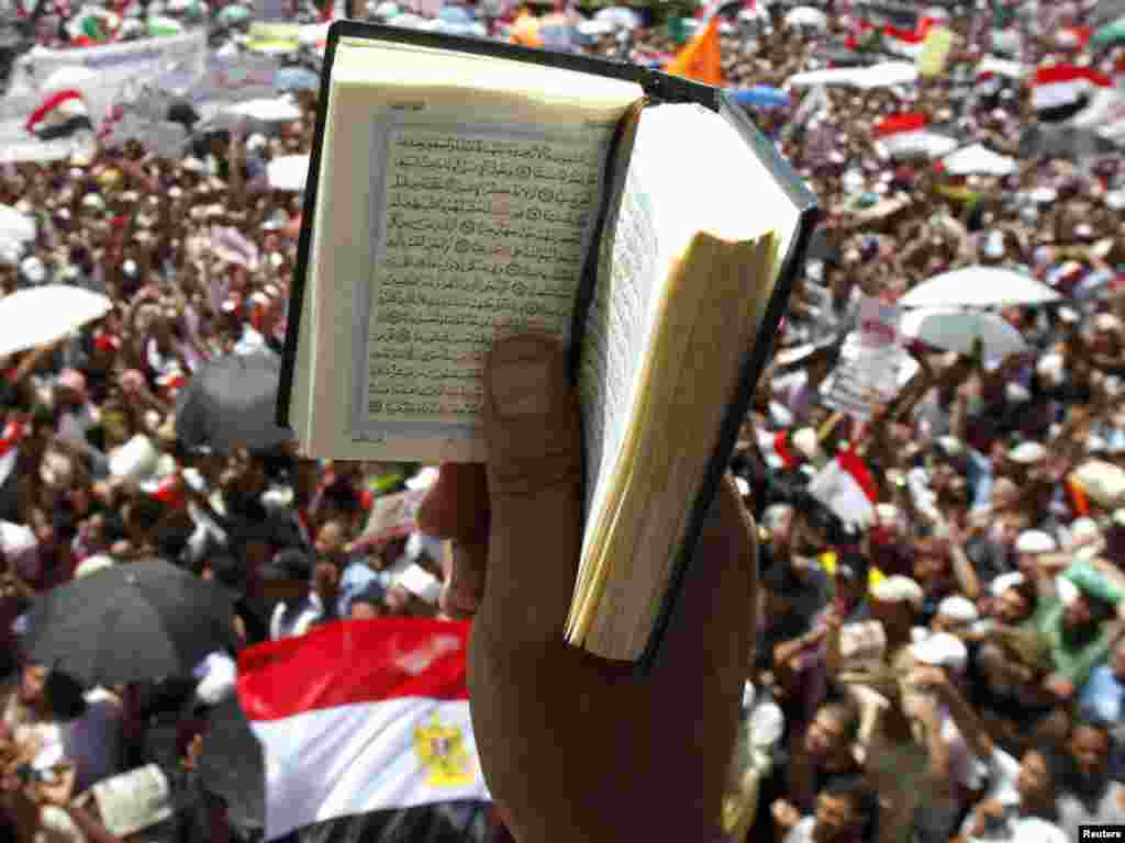 An Egyptian protester holds up a Koran while participating in a rally at Tahrir Square in Cairo on July 29. Photo by Mohamed Abd El-Ghany for Reuters