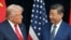US President Donald Trump (L) and China's President Xi Jinping greet each other as they arrive for talks at the Gimhae Air Base, located next to the Gimhae International Airport in Busan on October 30, 2025.