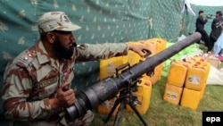 A Pakistani Frontier Corps officer displays arms and explosive materials seized during an operation in Quetta. (file photo)