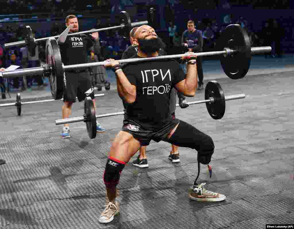 U.S. Staff Sergeant Jose Luis Sanchez, a retired Marine who lost a leg in Afghanistan, lifts weights during the Games of Heroes competition for disabled servicemen at the Sport Arena in Kyiv. About 50 wounded soldiers and veterans participated in the Games of Heroes, which included weightlifting, rope climbing, and rowing. (AP/Efrem Lukatsky)