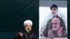 Hassan Rouhani speaks during a ceremony celebrating the 41st anniversary of the Islamic Revolution, on Azadi (Freedom) square in Tehran, February 11, 2020. Behind him is a poster showign Qassem Soleimani.