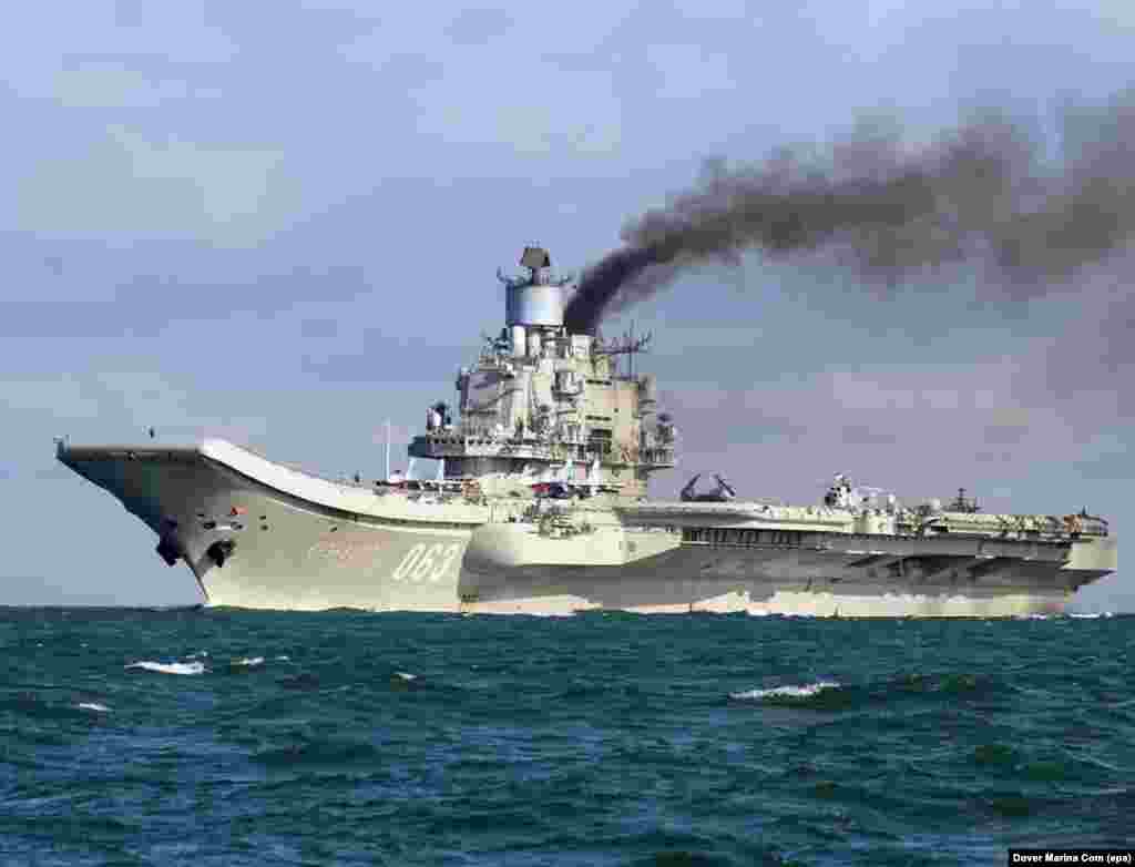 The Admiral Kuznetsov, billowing smoke as it passes through the English Channel on October 21, 2016. The diesel-powered carrier has attracted ridicule on Russian social media for its plume of black exhaust, but the apparent purpose of the vessel&#39;s mission to Syria is deadly serious.