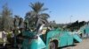 FILE: Pakistani security officials inspect the wreckage of a passenger bus at the scene of an accident in Khairpur district of southern Sindh province in 2014.