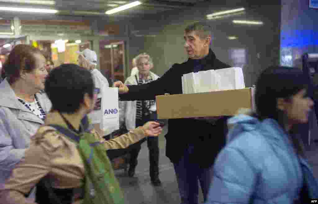 Czech billionaire Andrej Babis (center) hands out donuts while campaigning for his party ANO (Yes) on October 23 in Prague.