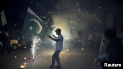 <p>Residents of Hyderabad, Pakistan, celebrate after the <a href="https://www.rferl.org/a/india-pakistan-border-ceasefire-violations-hold/33410660.html" target="_self"><strong>announcement of a cease-fire</strong></a> between Islamabad and New Delhi after weeks of exchanges over the disputed Kashmir region.