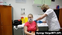 A nurse administers the Sputnik V vaccine to a patient in Nagykanizsa, Hungary, on April 13.