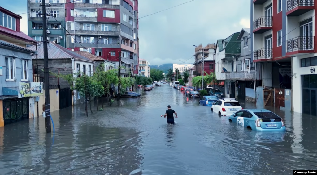 A resident wades through floodwaters in Batumi, Georgia, on August 8.
