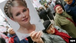 A Ukrainian opposition supporter holds aloft a portrait of jailed ex-Prime Minister Yulia Tymoshenko during a protest in Kyiv last month.