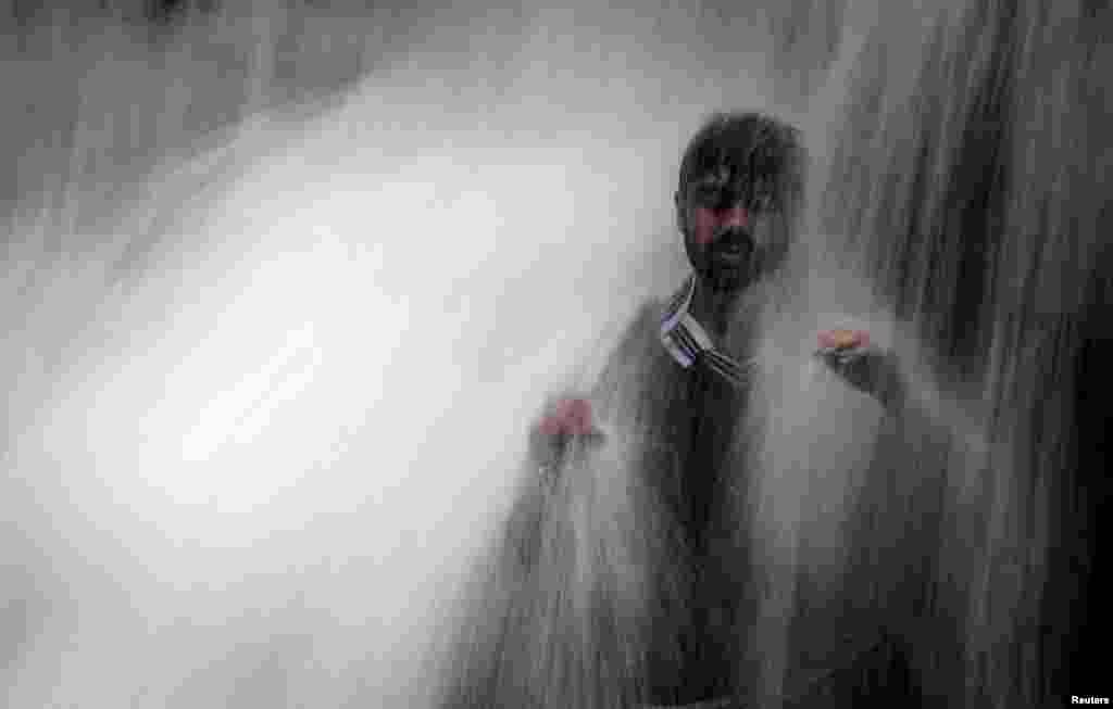 A man cools off at the Tungareshwar waterfall on the outskirts of Mumbai, India. (Reuters/Shailesh Andrade)