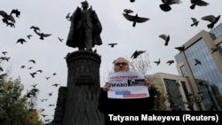 A man takes part in a one-person protest demanding that authorities allow opposition candidates to run in the upcoming local elections and release people arrested for participation in opposition rallies, in Moscow on August 17.