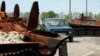 A man drives his car among destroyed Russian armor in a village near Kharkiv on May 11. 