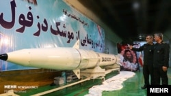 Iran's Islamic Revolutionary Guards Corps commanders show off a new weapon in February.