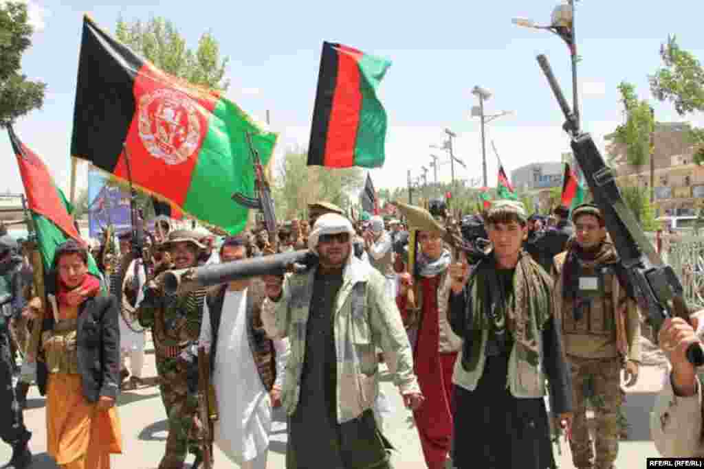 Armed citizens in Ghor Province march in opposition to the Taliban on July 6.