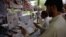 Pakistanis read newspapers with a front page headline about U.S. President Donald Trump at a stall in Islamabad on August 23.