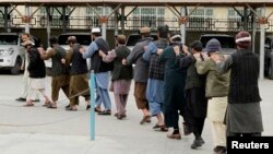 Captured Taliban fighters are presented to the media in Kandahar province, January 7, 2014.