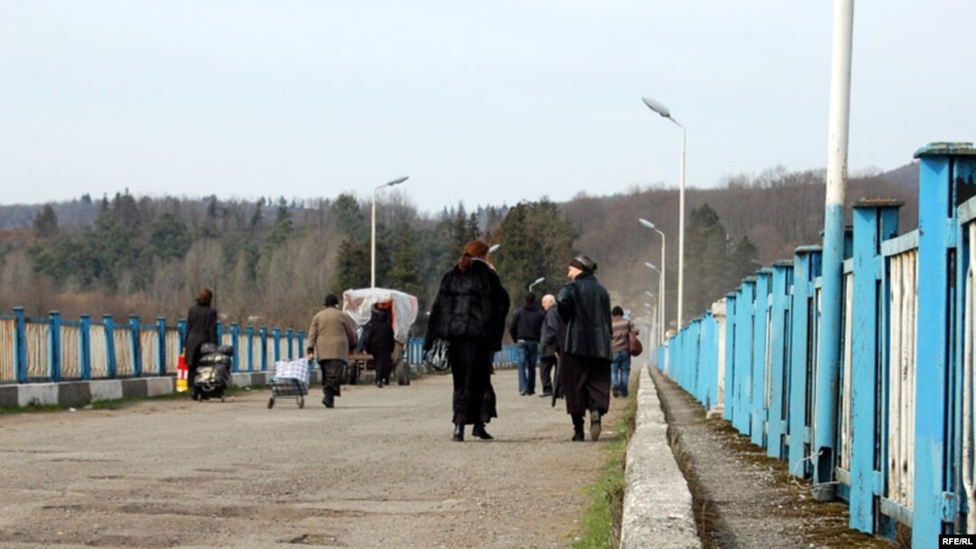 People cross the neutral zone of Enguri Bridge, between Abkhazia and the rest of Georgia.